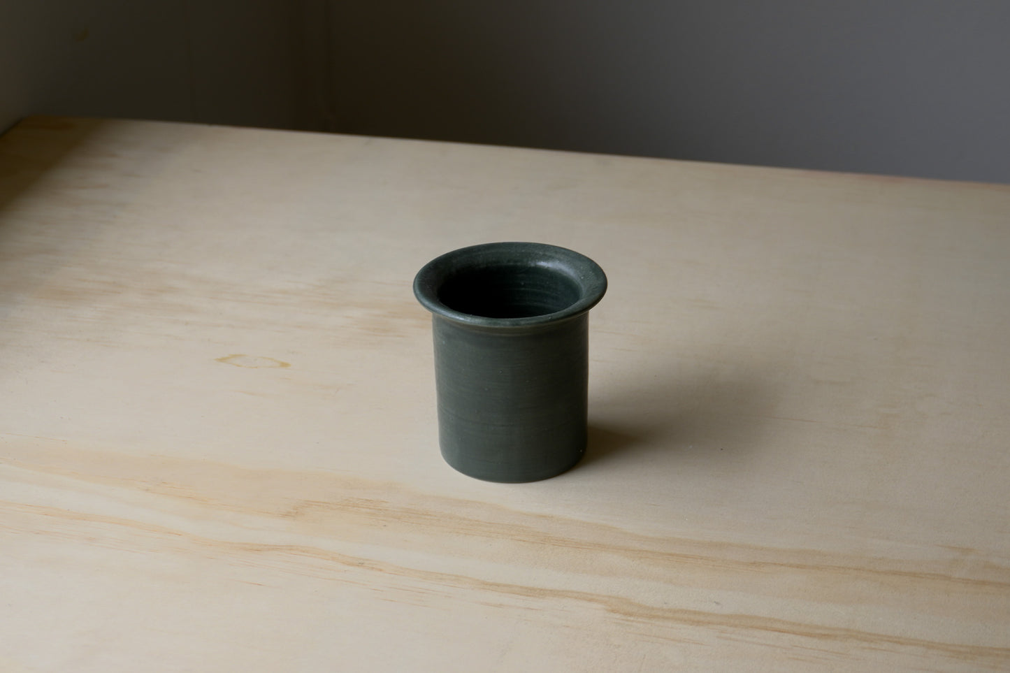 flared forest green vessel