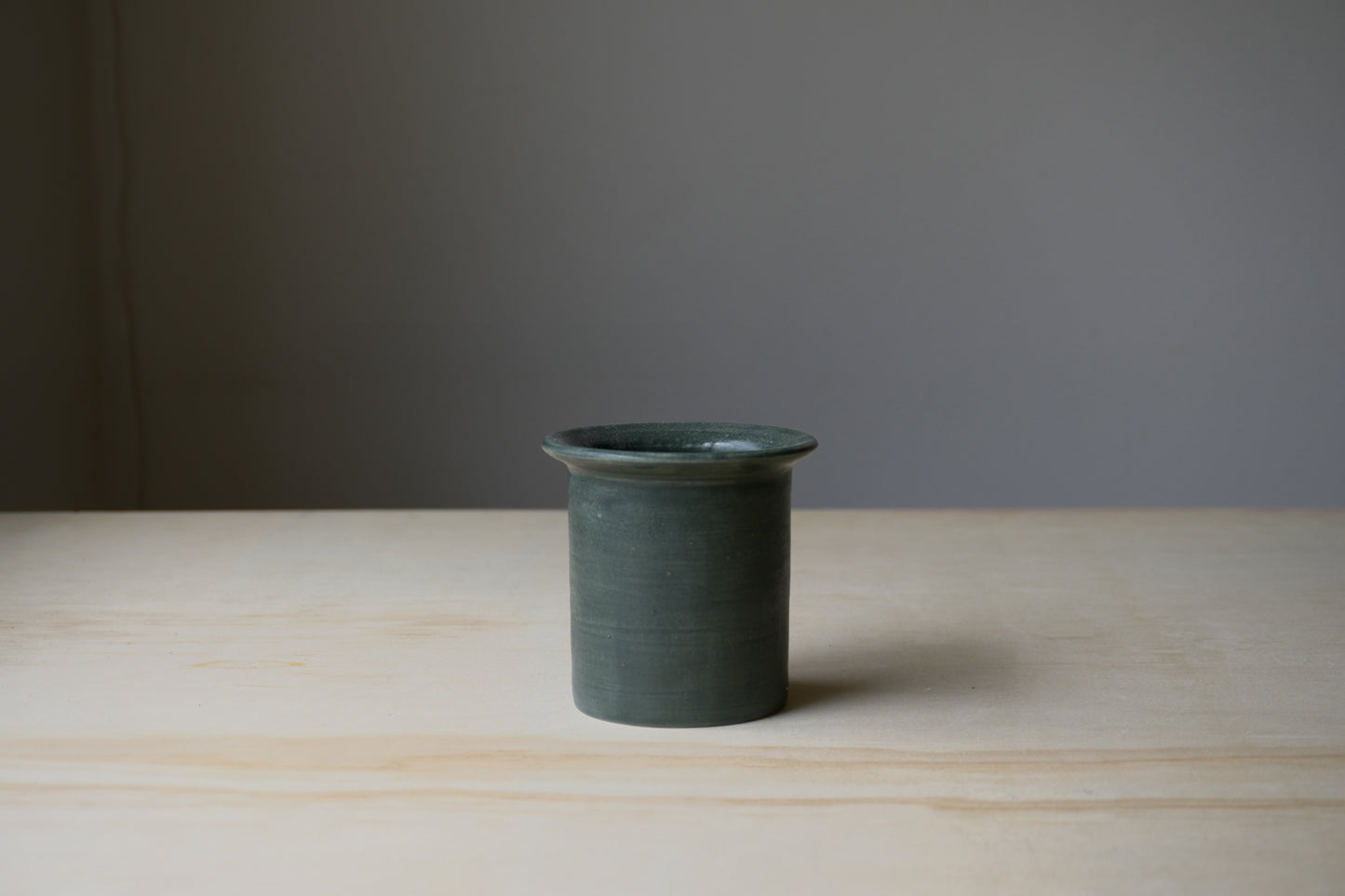 flared forest green vessel